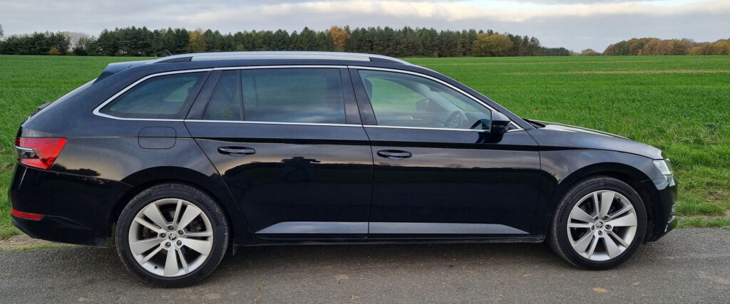 Private Hire Taxi in front of a green field in North Norfolk